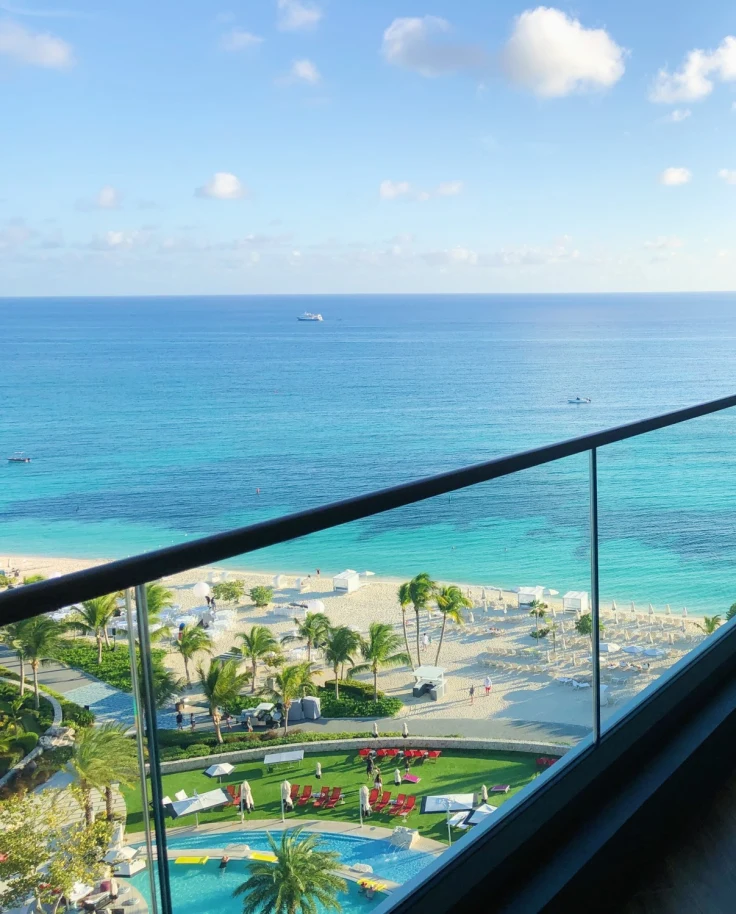 Balancony with a glass railing and an ocean view.