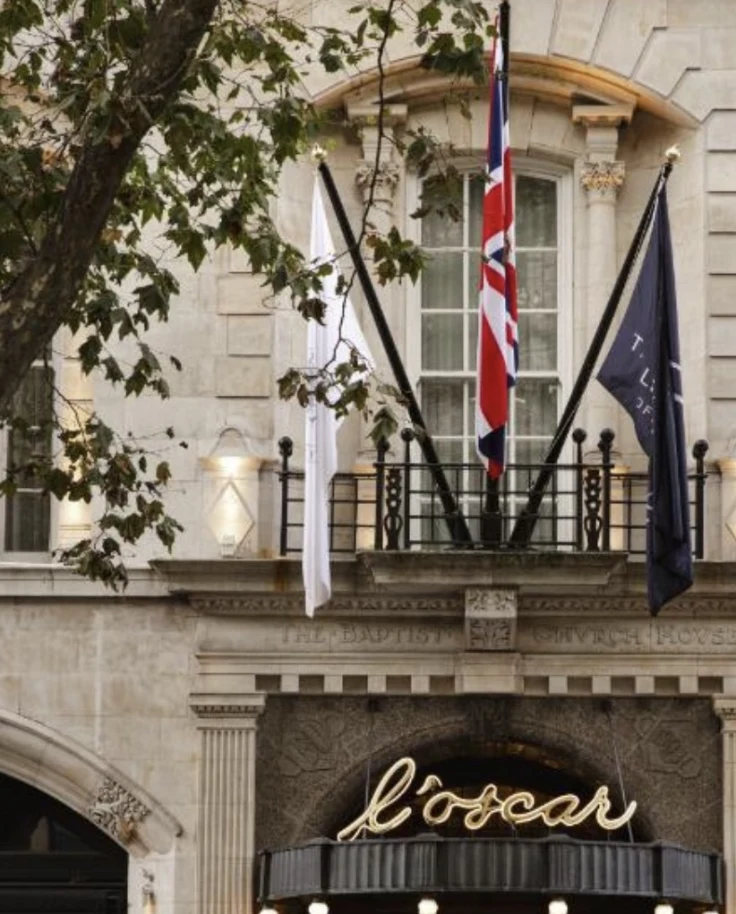 Hotel Exterior in London with the countries flags and upscale lighting.