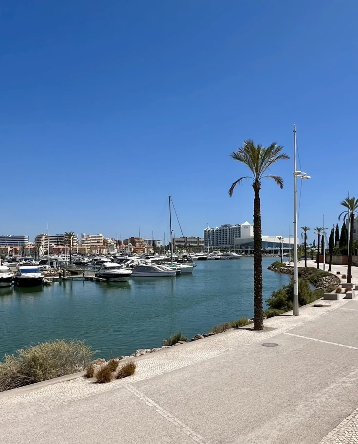 A view of the marina from Domes Lake Algarve hotel with boats docked and a path.