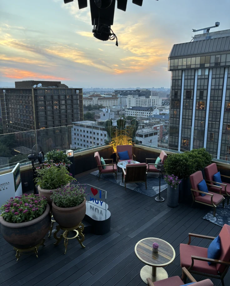 Aerial view of a rooftop patio with a seating area of red charis