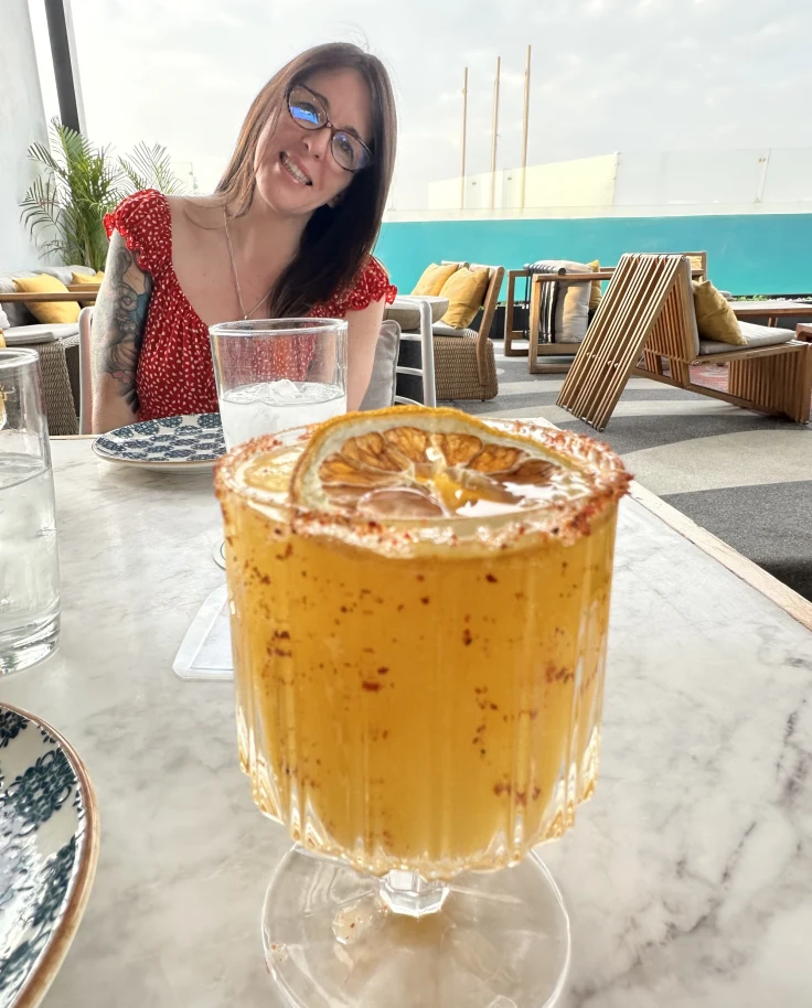 Enjoying spicy mango mezcal margaritas at Cabuya rooftop on a sunny day.