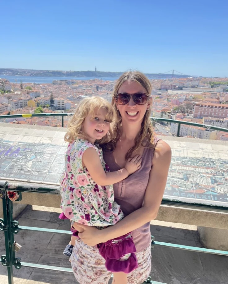 Travel advisor posing at a tourist outlook spot on a sunny day.
