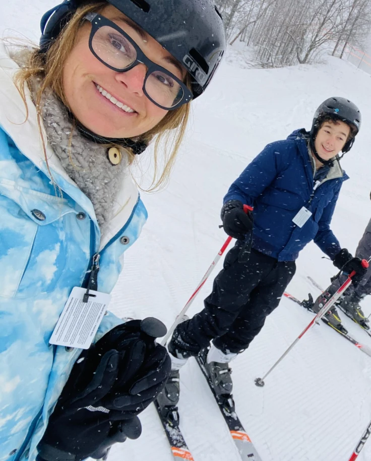 A family on skis posing for a photo