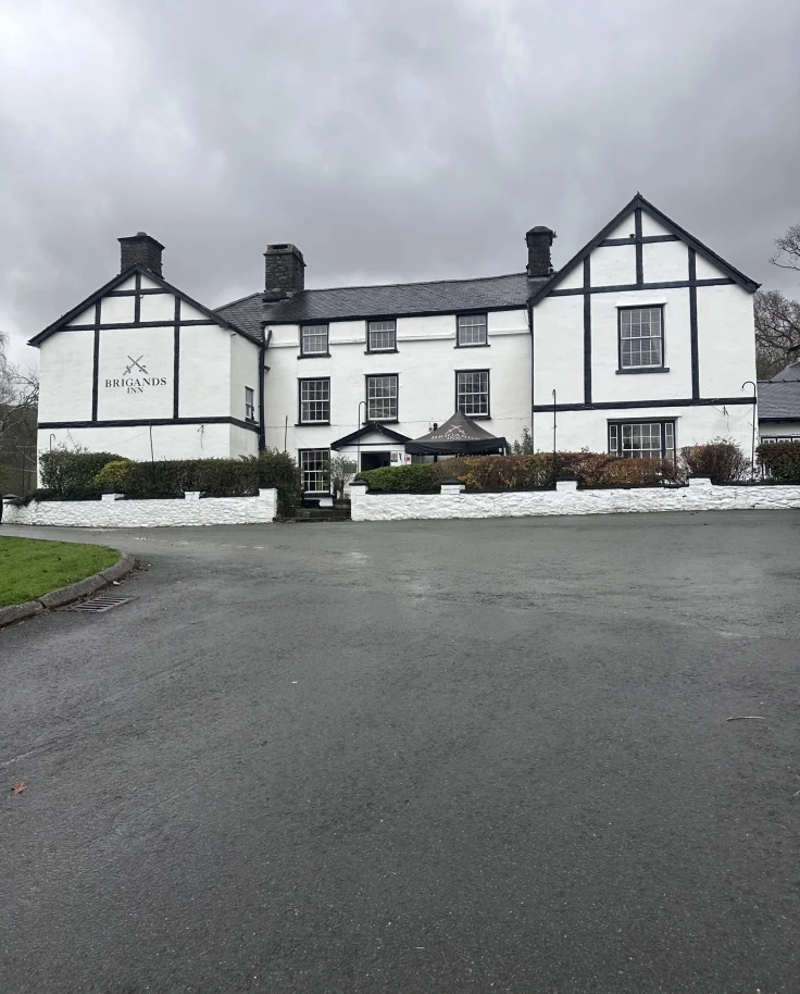 Outside view of a black and white Tudor-style inn.