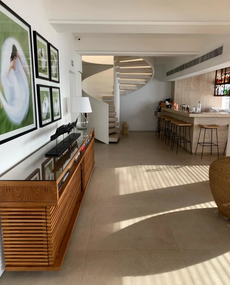 Modern and light hotel interior showing bar and paintings on wall