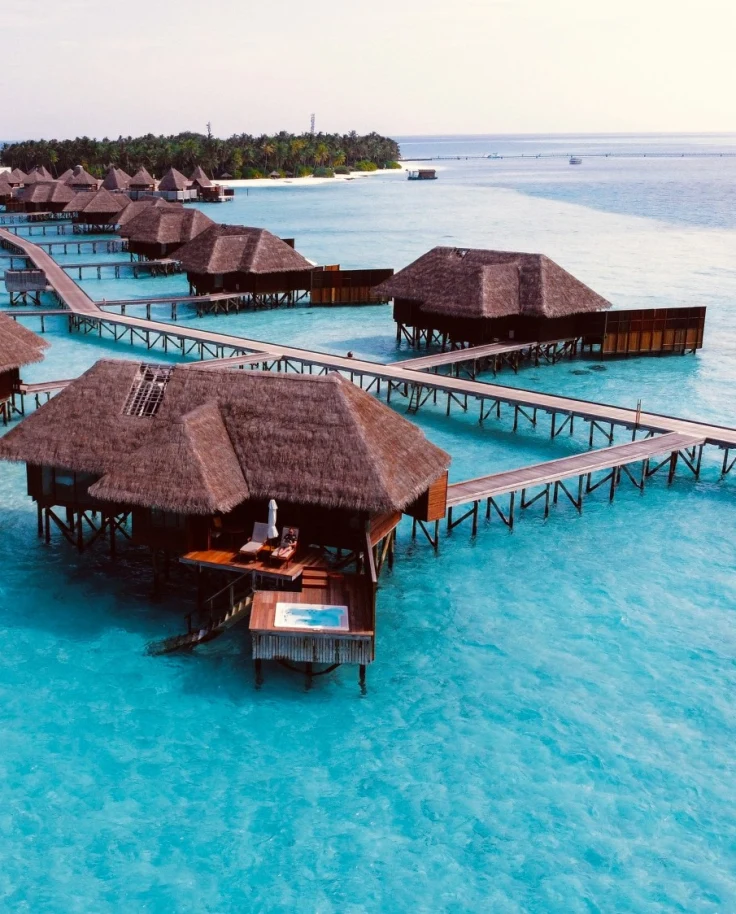 Brown wooden cottage on a blue body of water during the daytime