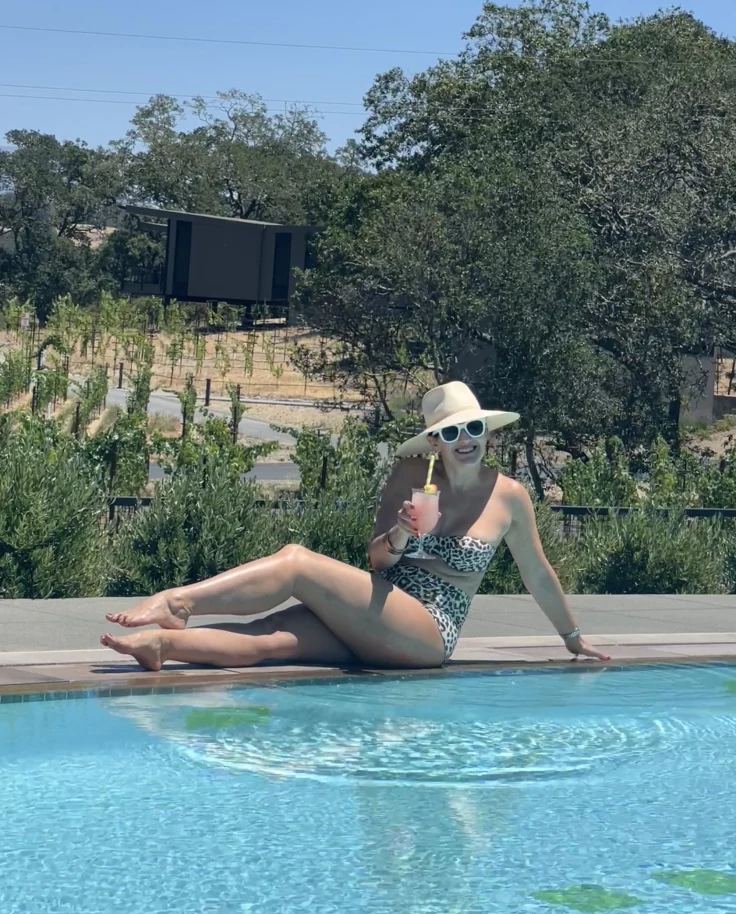 Travel advisor posing by a pool