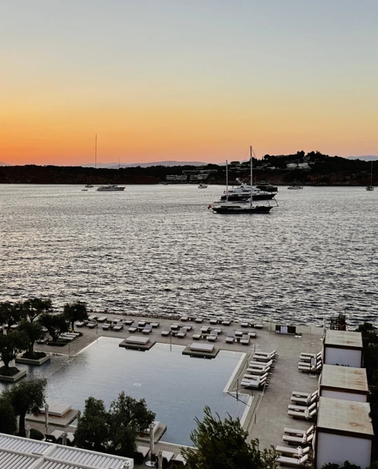Sunset view from the hotel at seaside, Athens as the sun dips below the ocean horizon.