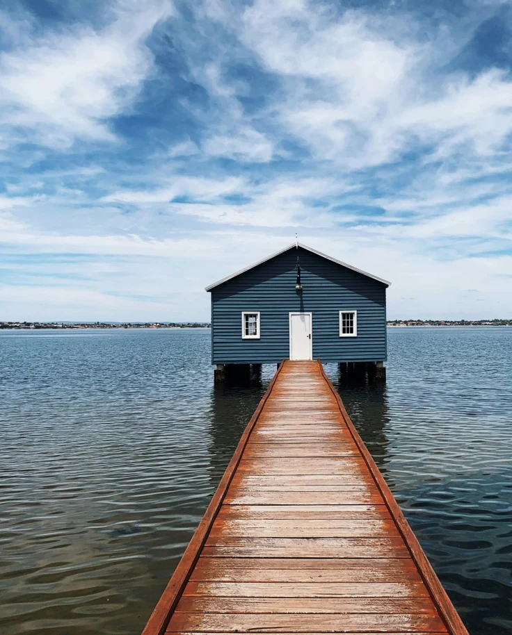 Brown wooden dock on the sea under blue sky during the daytime