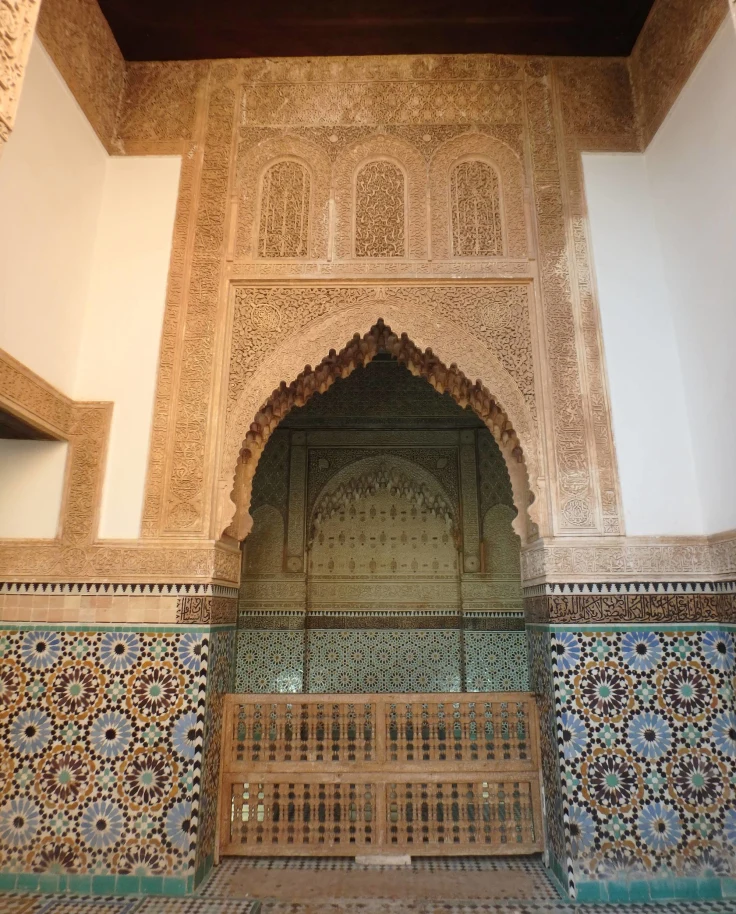 A tall, arched doorway with blue and brown tiles