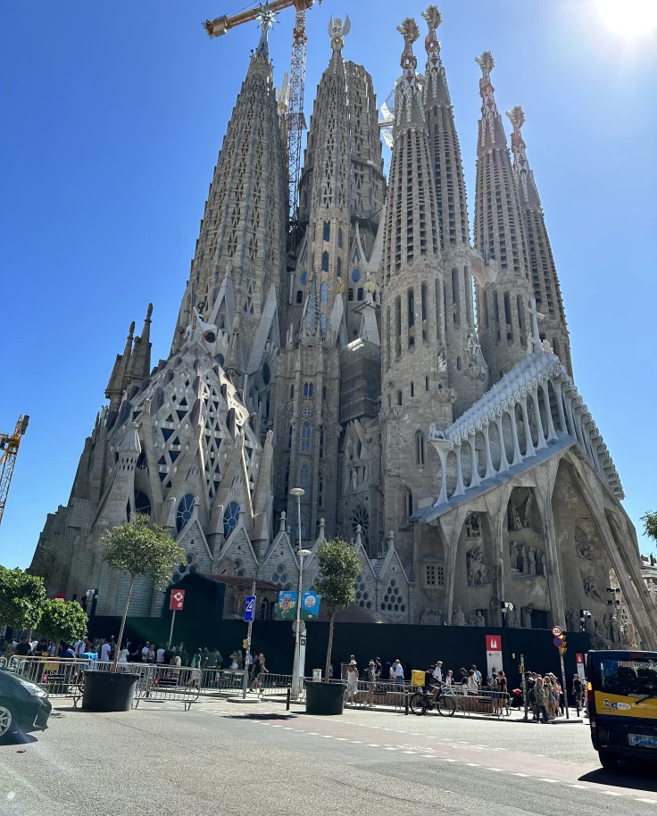 A low-angled view of a tall cathedral in a city street