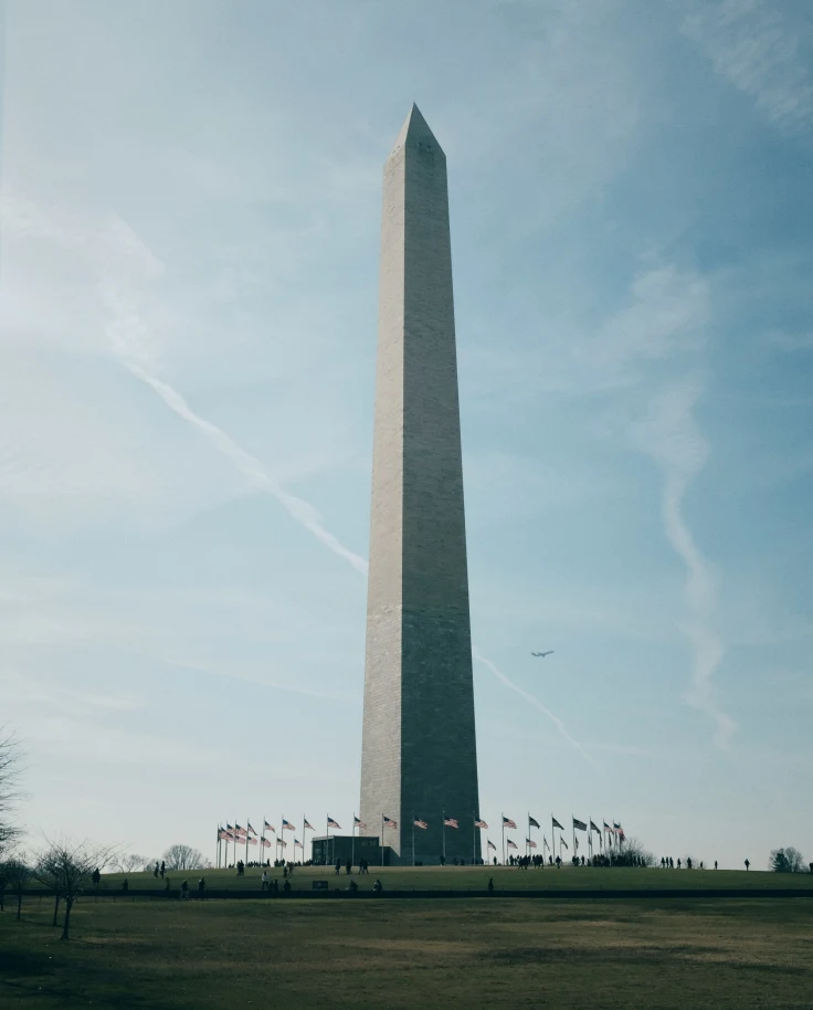 Washington Monument with a plane in the background