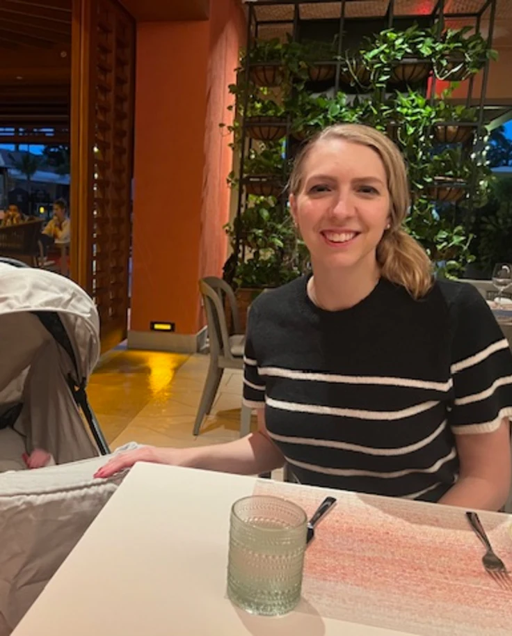 Travel advisor posing with a baby in a restaurant