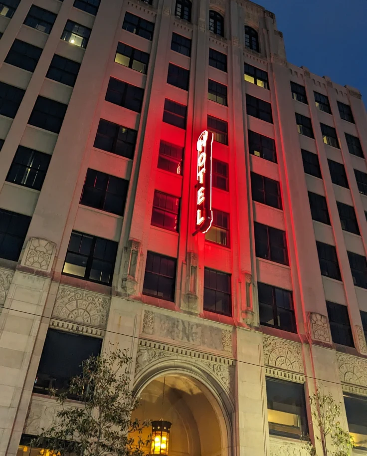 A low-angled view of a hotel building at nighttime