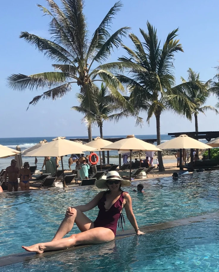 Emily laying on the pool