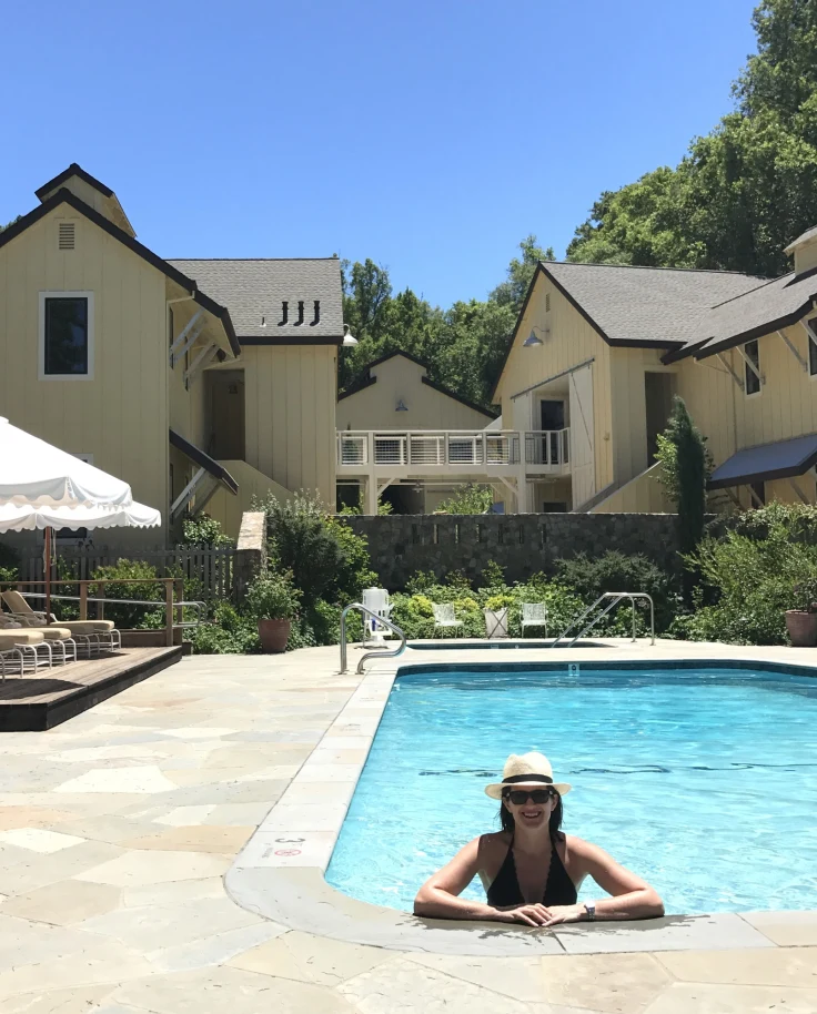 Travel advisor posing in a pool