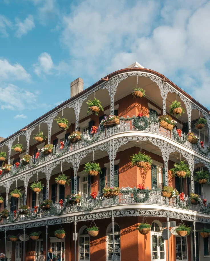 A building with balconies and flowers.