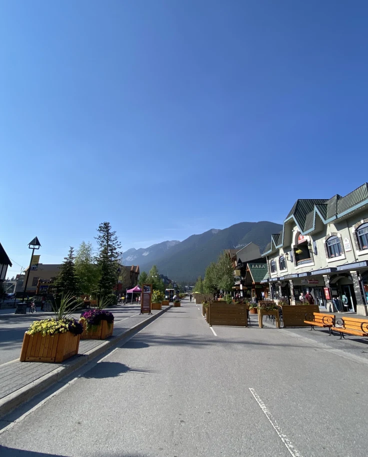 A road with mountains at the back on a sunny day.