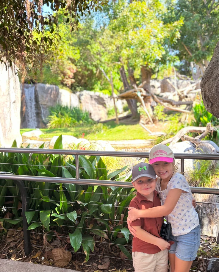 Two children posing at the zoo.