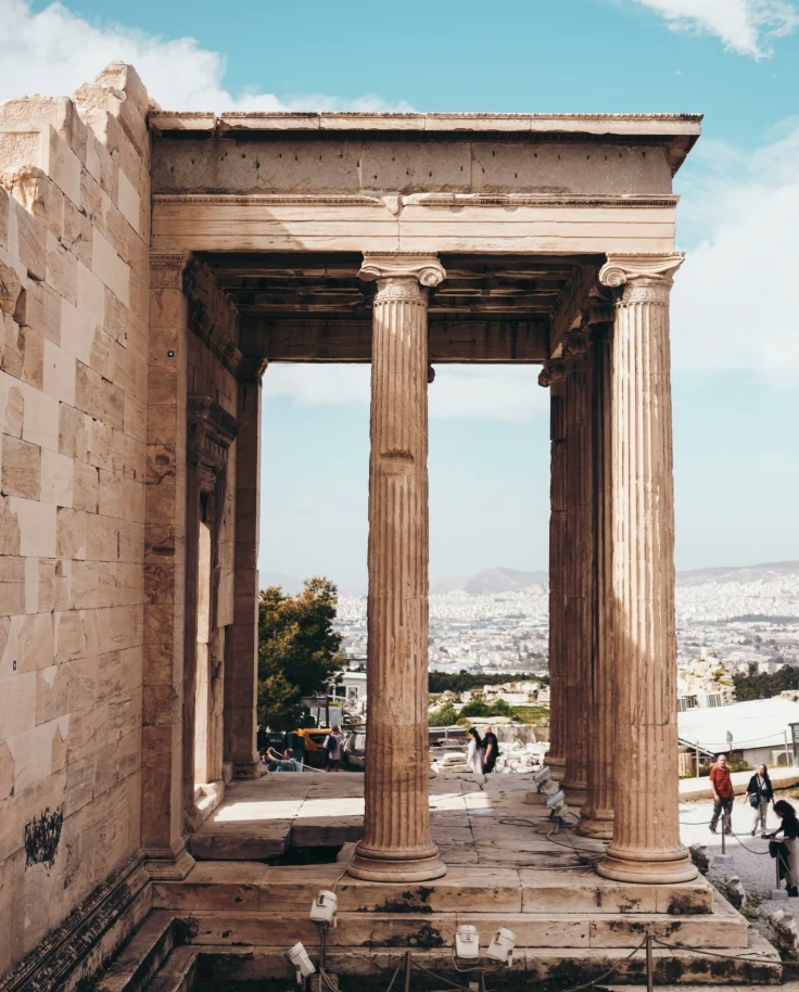Ruins of an old building with pillars on a sunny day.