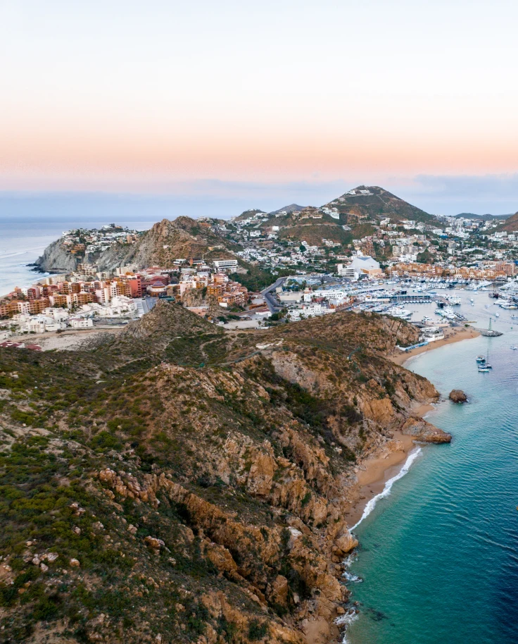 aerial view of land next to body of water during sunset