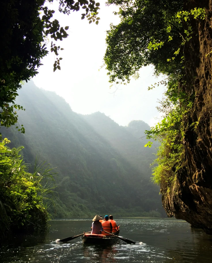 A picture of a group of people rowing a boat on water during the daytime.