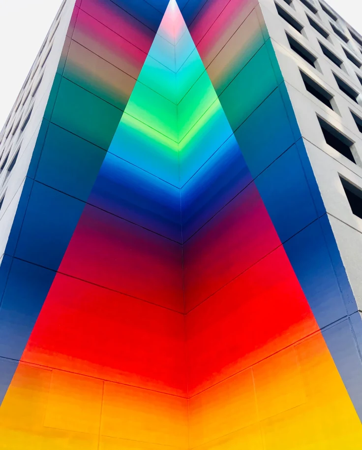 A multicolored building picture taken from a low angle.
