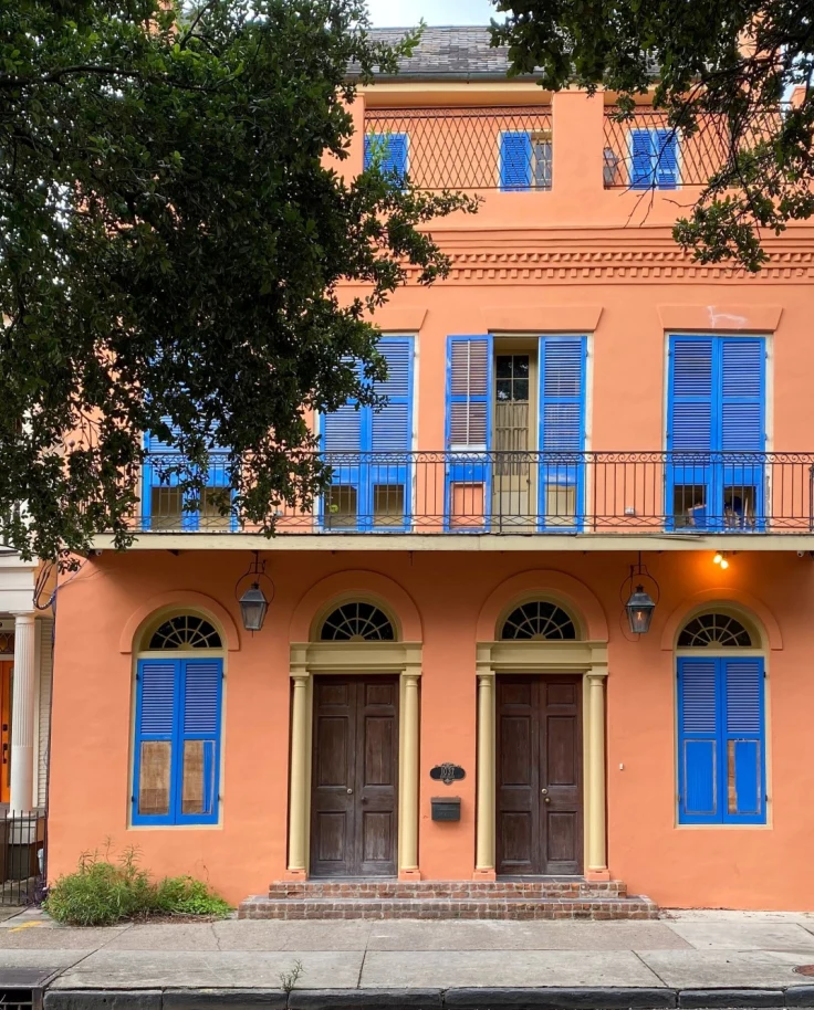 orange New Orleans home with blue shutters