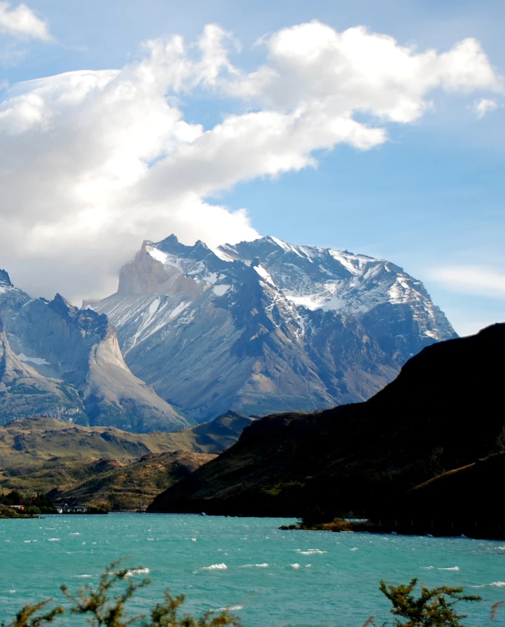 bright blue lake with sharp snow-capped mountains during daytime