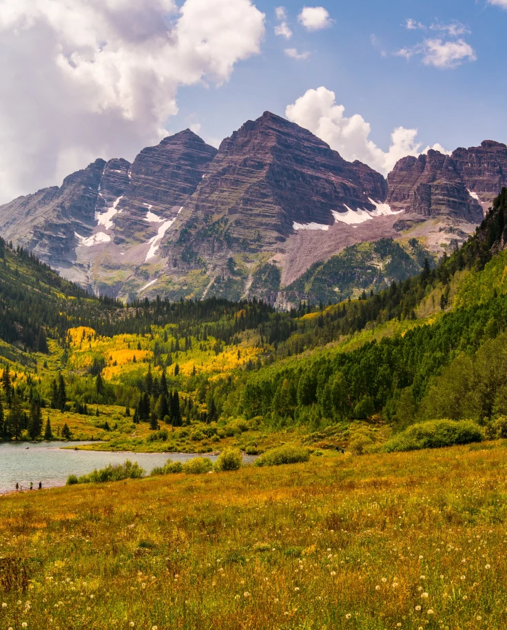 Maroon Bells, the iconic twin peaks in the Colorado Rockies, renowned for their stunning reflection in Maroon Lake, attracting photographers and nature enthusiasts worldwide."