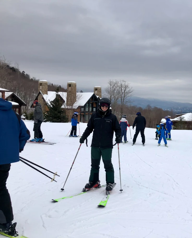 People skiing in the snow during a cloudy day