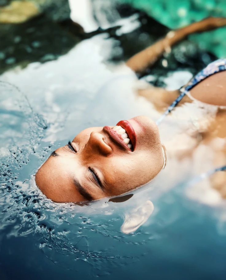 Floating woman on a waterbody.