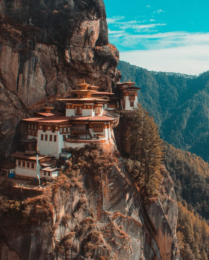 A scenic view of Tiget's Nest Monastery nestled on the edge of a cliff in Bhutan.