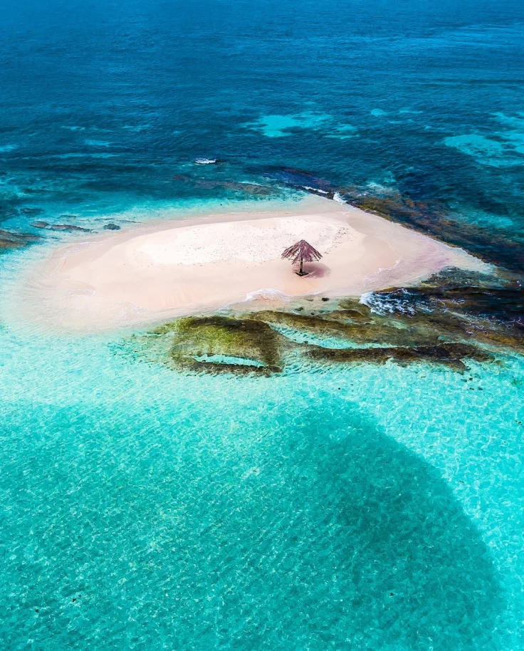 Blue water surrounds Mopion Island, Saint Vincent and the Grenadines.