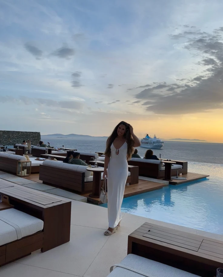 A woman on a beach side restaurant.