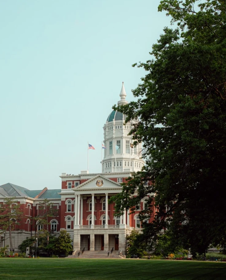 A red building in the distance with a dome on top