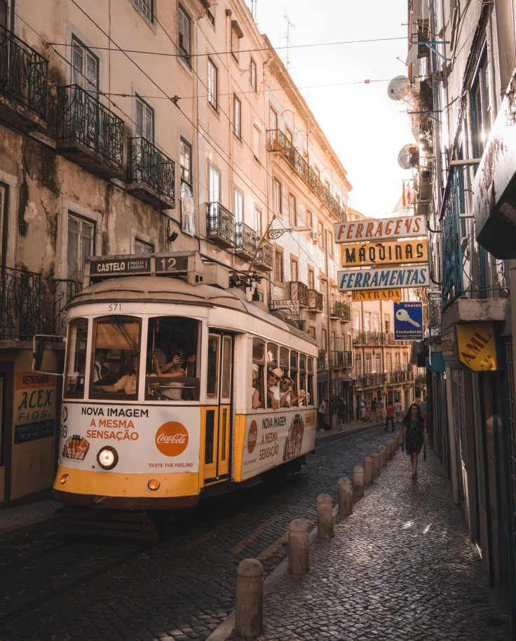 urban tram car in a narrow cobblestoned alleyway