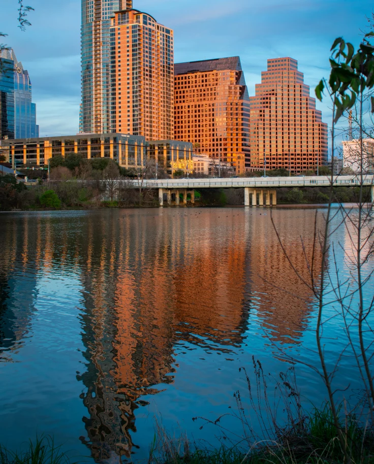 A sunset view over the lake of buildings in Austin.