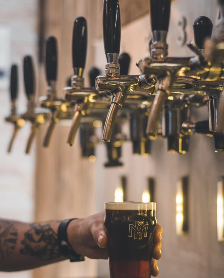 A cup of beer being filled.