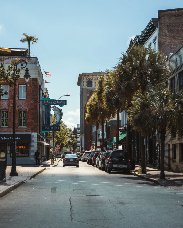 small town street lined with trees on a sunny day