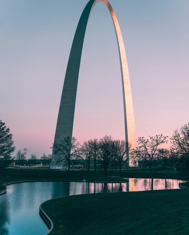 A big silver arch like architecture during daytime.