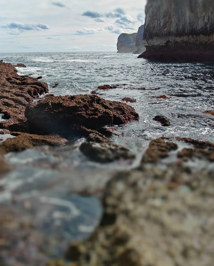 View of ocean from a rocky shore.