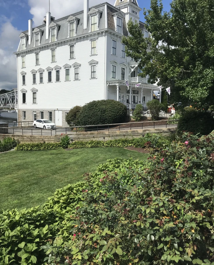 A white building in a garden.