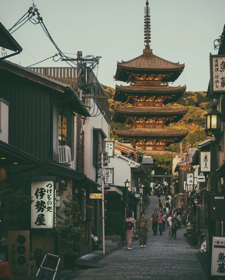 street lined with buildings with temple in the background