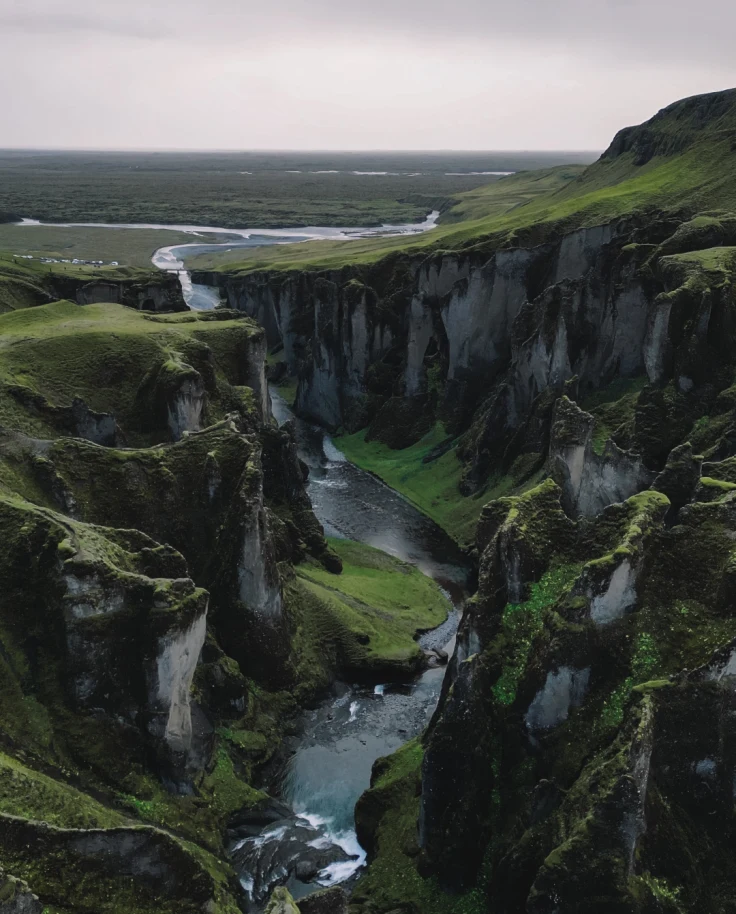 An aerial view of a valley and cliffs at nighttime