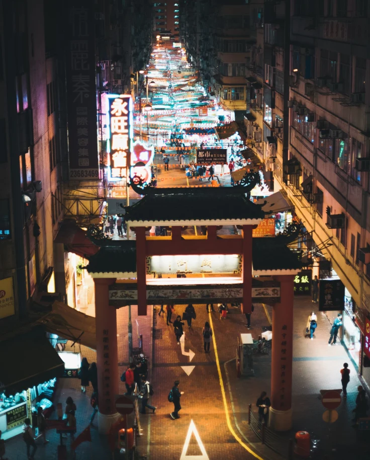 long city street with night market lit up by