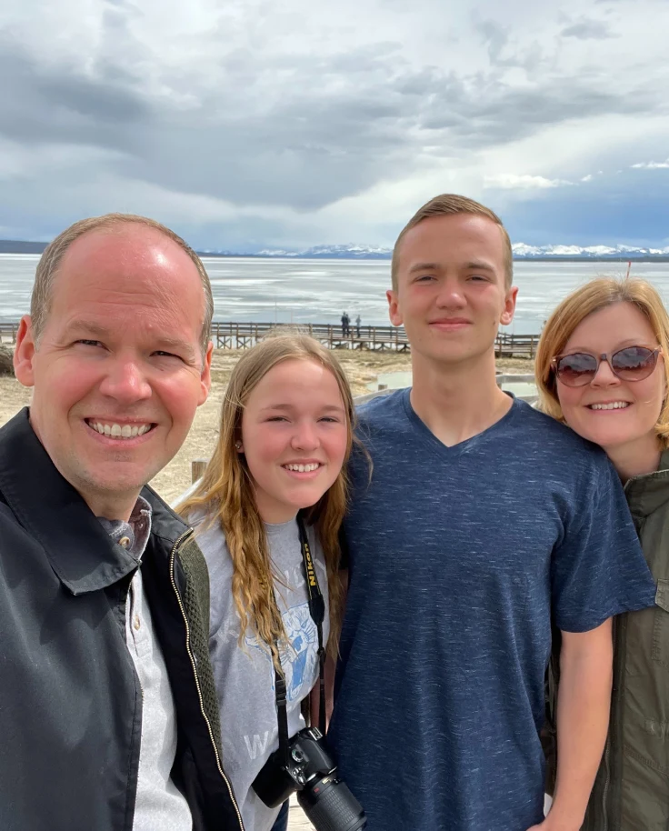 A family smiling for a selfie photo