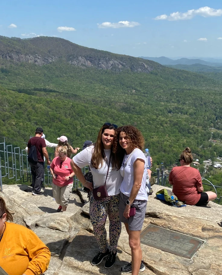 An aerial view of people standing on a cliff.