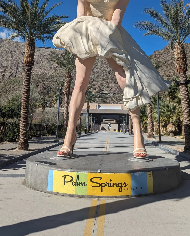A Marilyn Monroe statue in the desert taken during daytime.