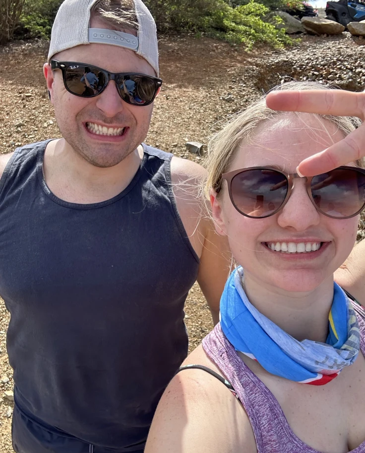 A couple outdoors posing for a selfie.